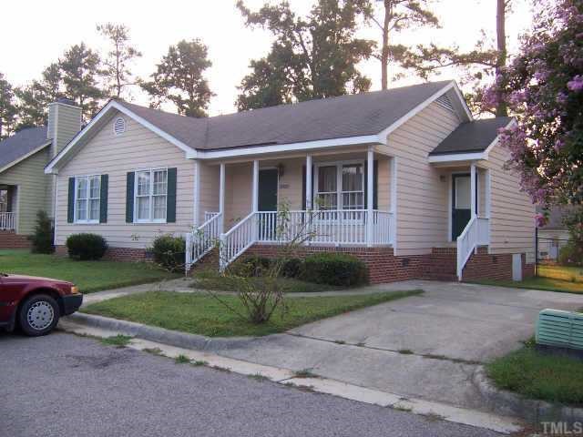 a front view of a house with a garden and plants