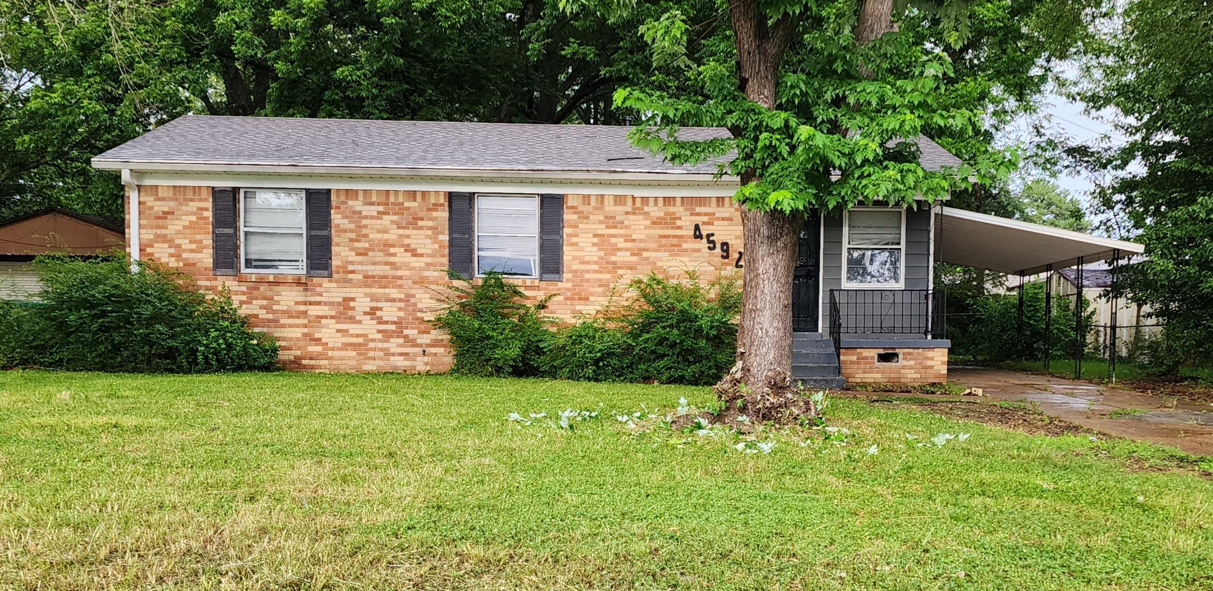 4592 Neely Road Memphis, TN 38109 - Photo 1 of 8 a front view of a house with garden