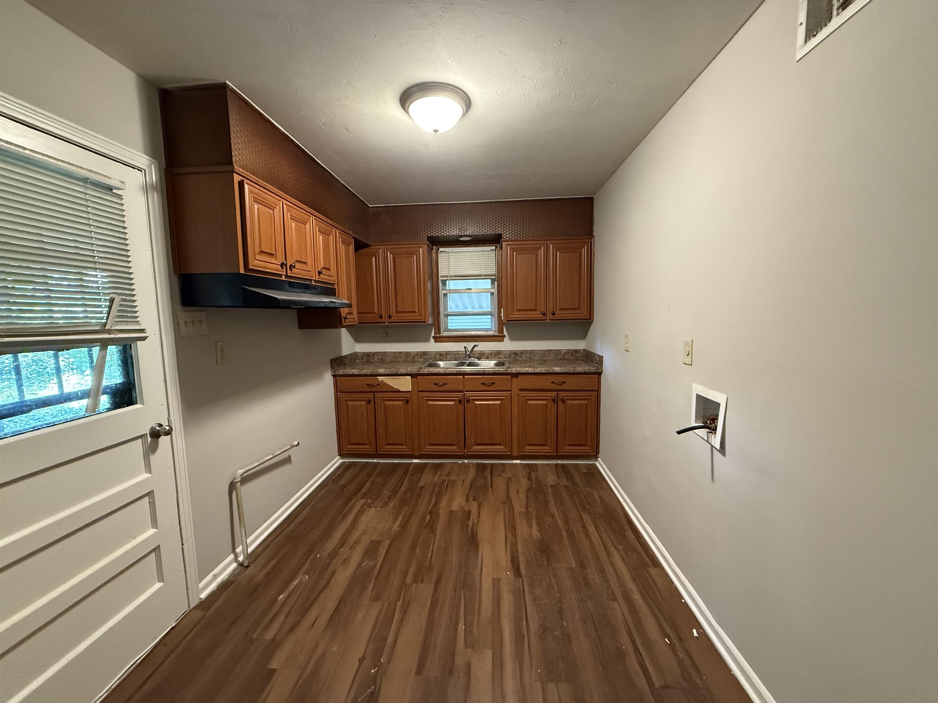 4592 Neely Road Memphis, TN 38109 - Photo 3 of 8 a kitchen with granite countertop white cabinets and white appliances