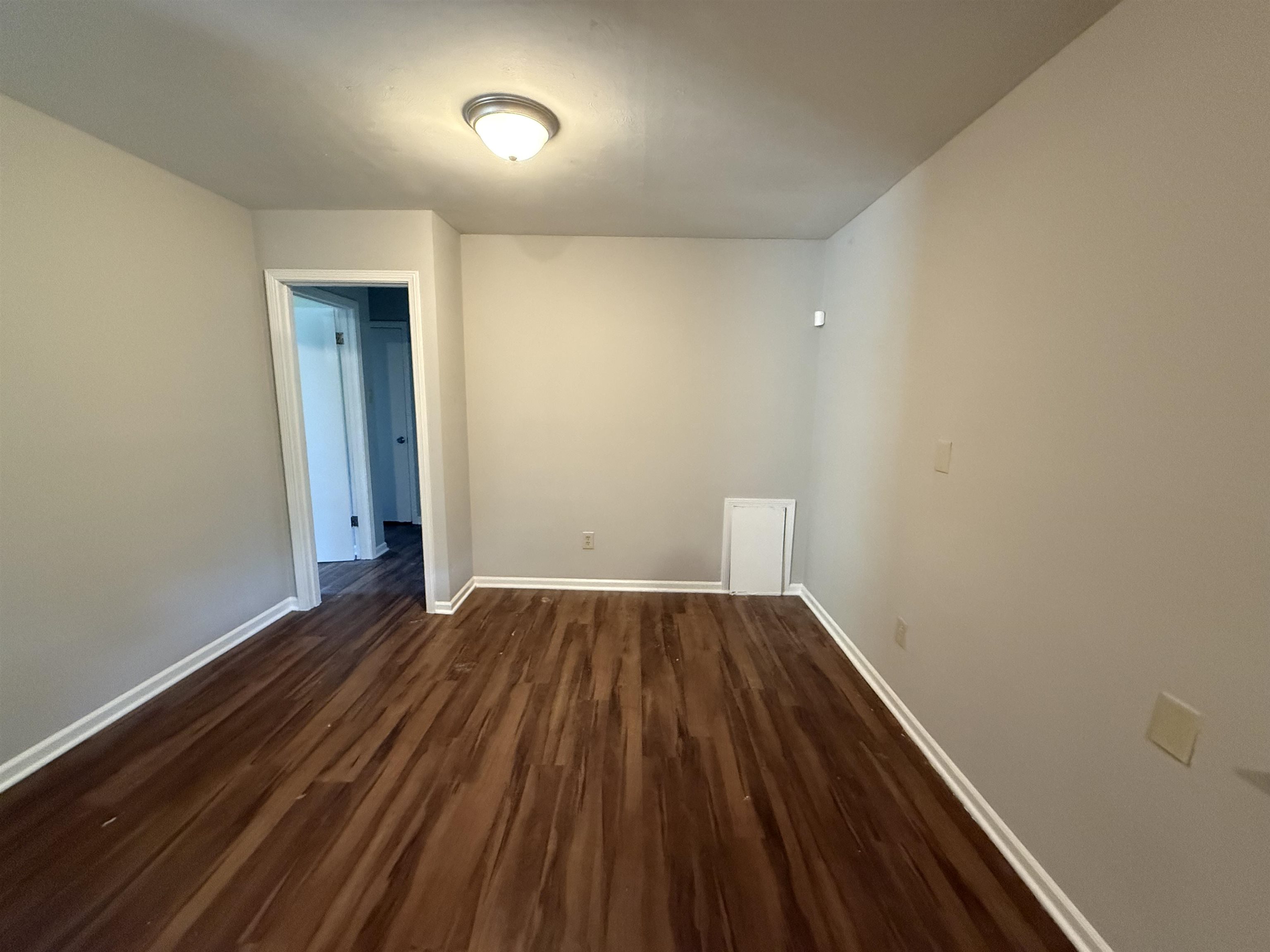 4592 Neely Road Memphis, TN 38109 - Photo 4 of 8 a view of an empty room with wooden floor