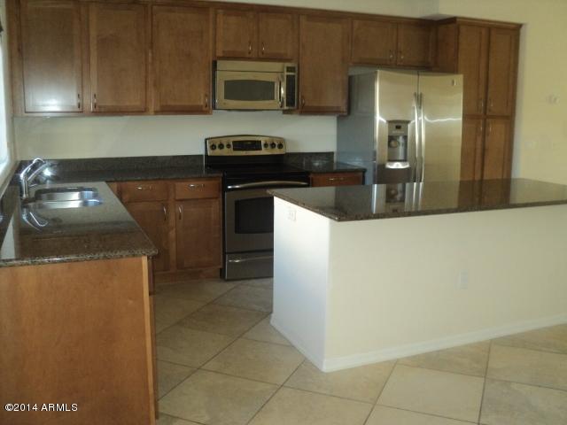 3935 East Rough Rider Road, Unit 1201 Phoenix, AZ 85050 - Photo 4 of 26 Island Kitchen w/SS Appliances & Granite