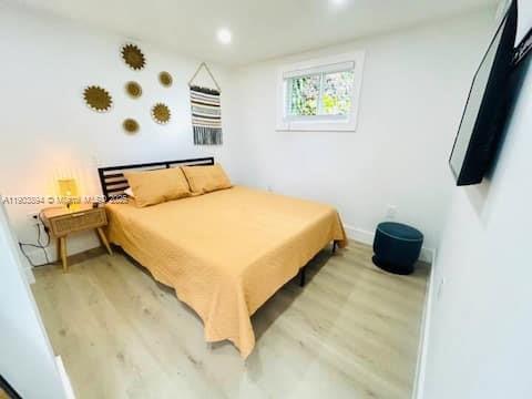 a bedroom with a bed and a window