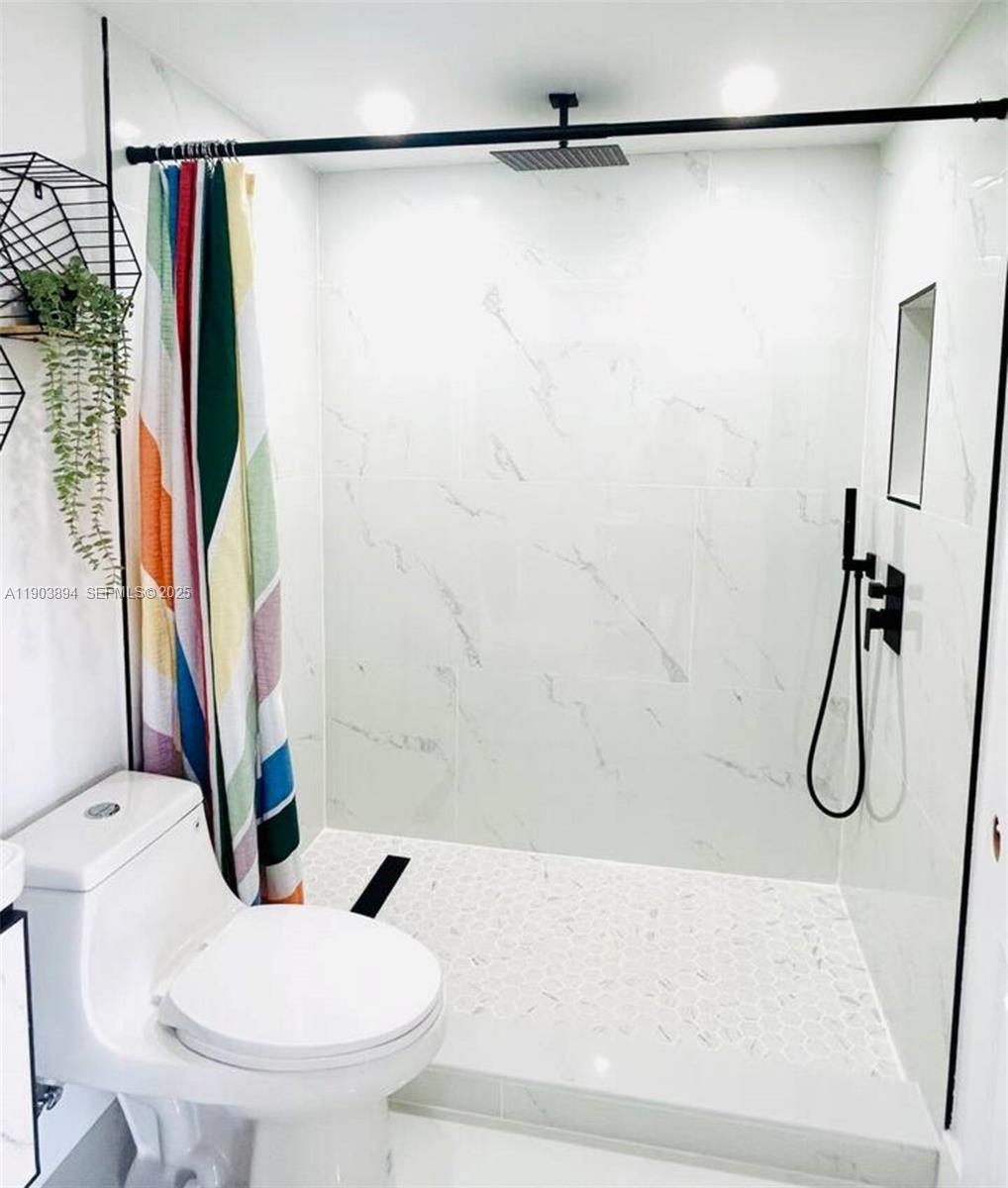 2612 Southwest 12th Street Miami, FL 33135 - Photo 2 of 3 a bathroom with a sink a toilet and a shower