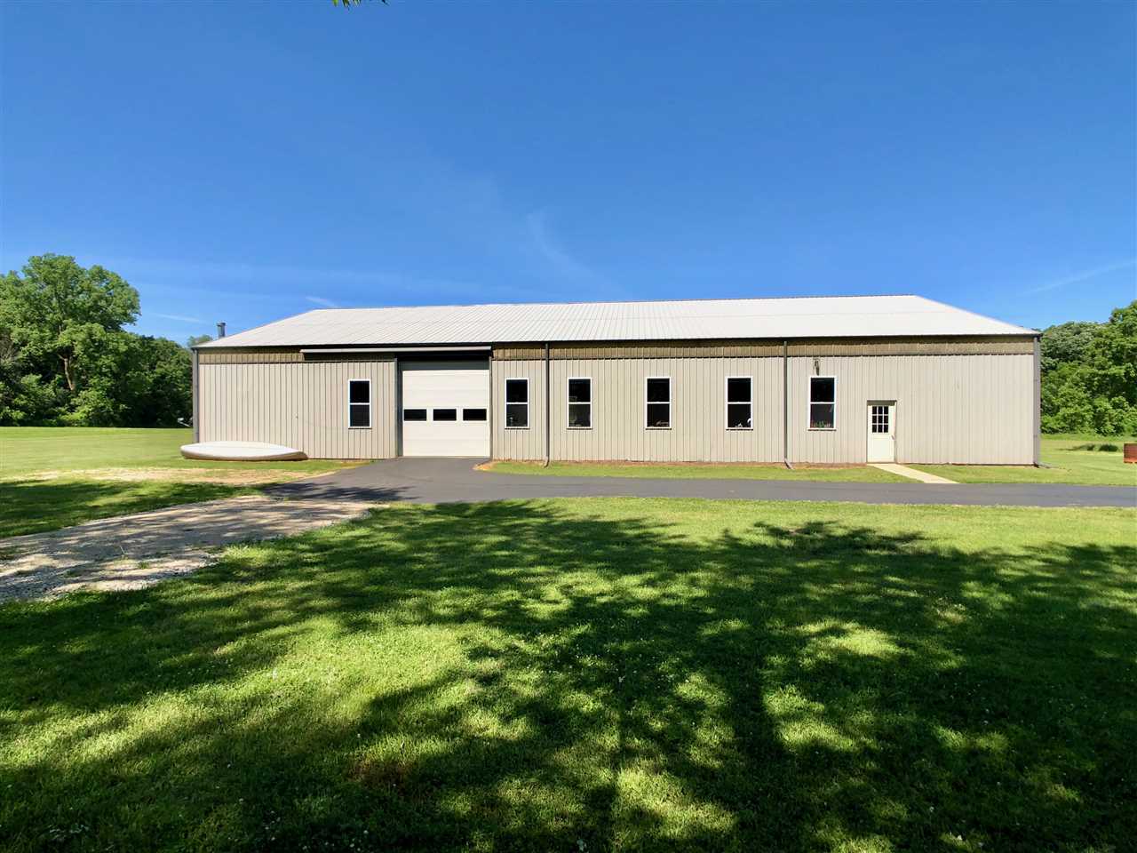 747 Searls Road Amboy, IL 61310 - Photo 13 of 40 a view of a white house with a big yard