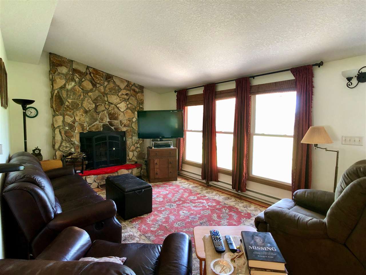 747 Searls Road Amboy, IL 61310 - Photo 28 of 40 a living room with furniture a flat screen tv and a floor to ceiling window