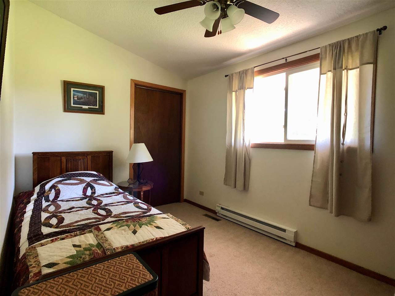747 Searls Road Amboy, IL 61310 - Photo 31 of 40 a bedroom with a bed a dresser and window