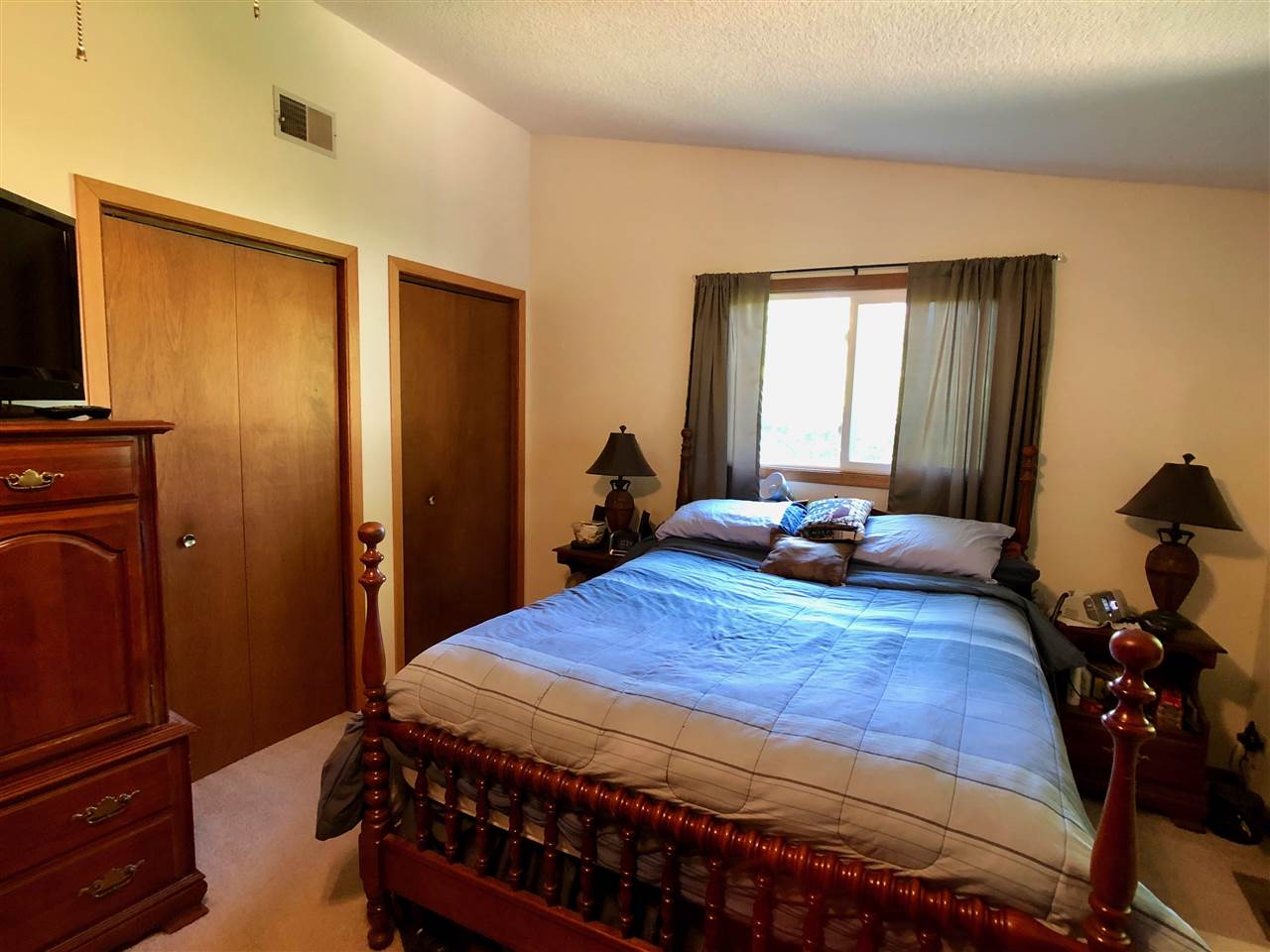 747 Searls Road Amboy, IL 61310 - Photo 34 of 40 a bedroom with a bed and wooden floor