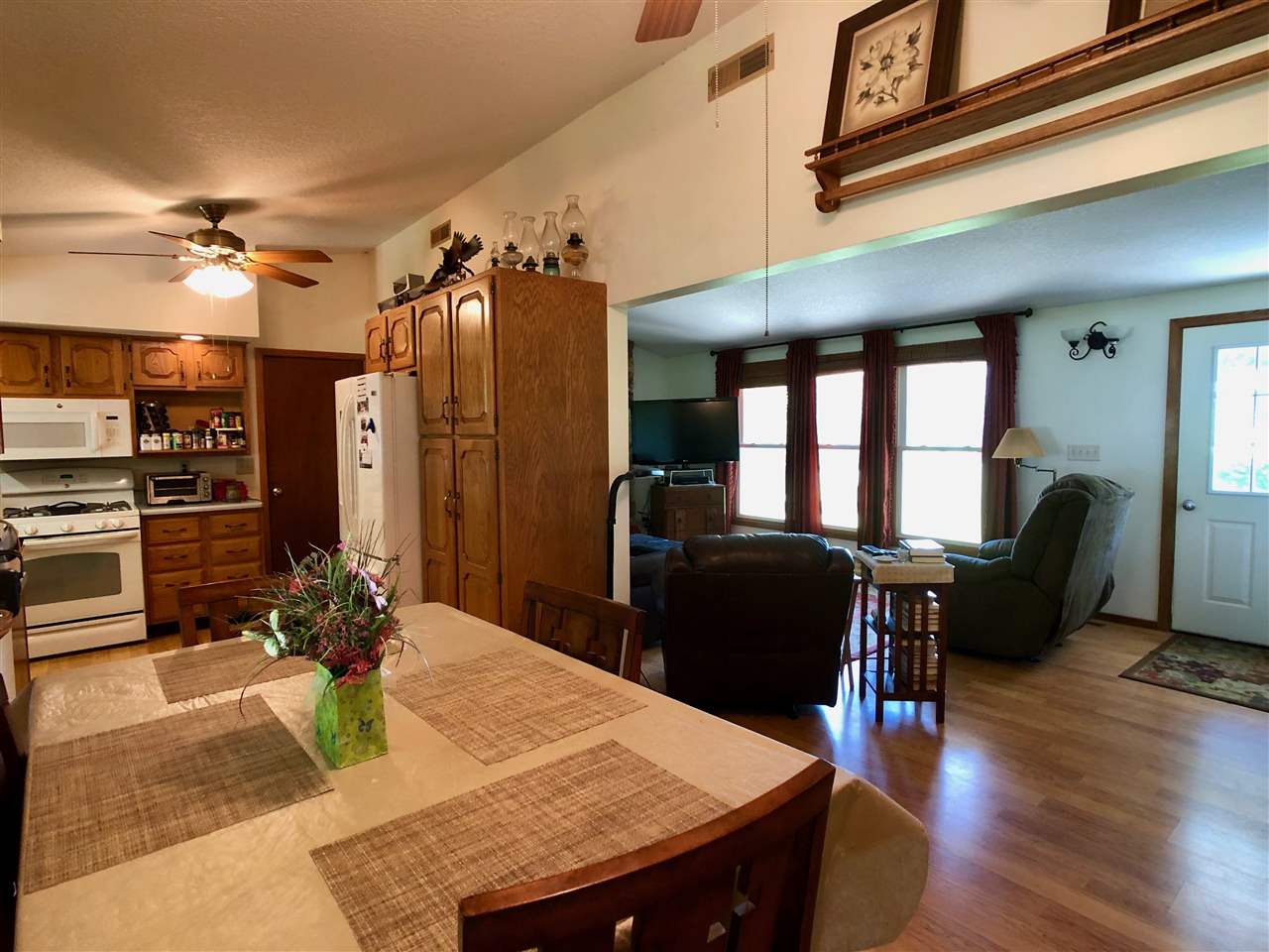 747 Searls Road Amboy, IL 61310 - Photo 36 of 40 a view of a dining room with furniture a chandelier and wooden floor