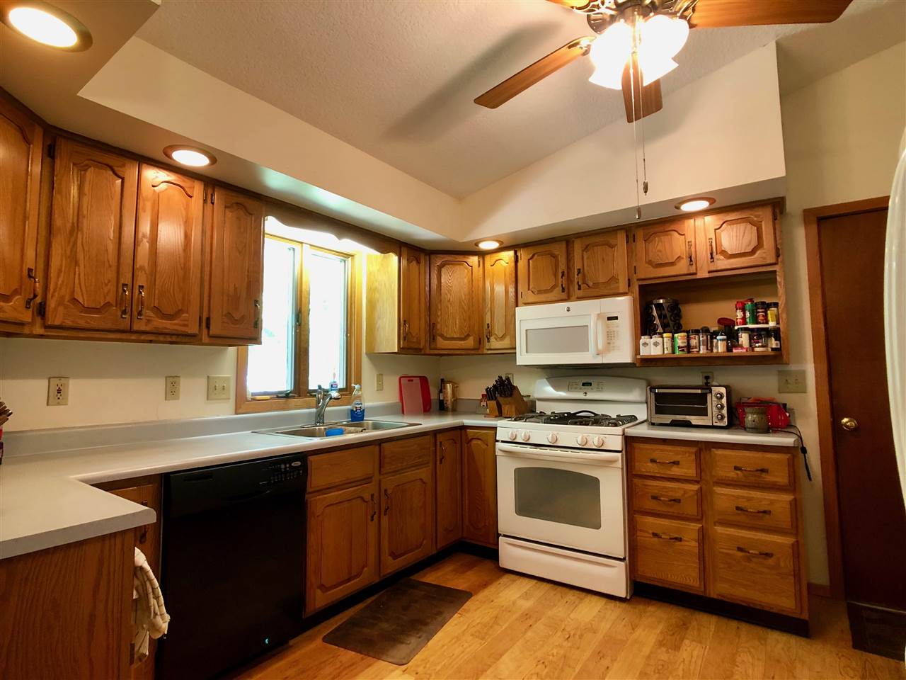 747 Searls Road Amboy, IL 61310 - Photo 38 of 40 a kitchen with stainless steel appliances a sink a stove and cabinets