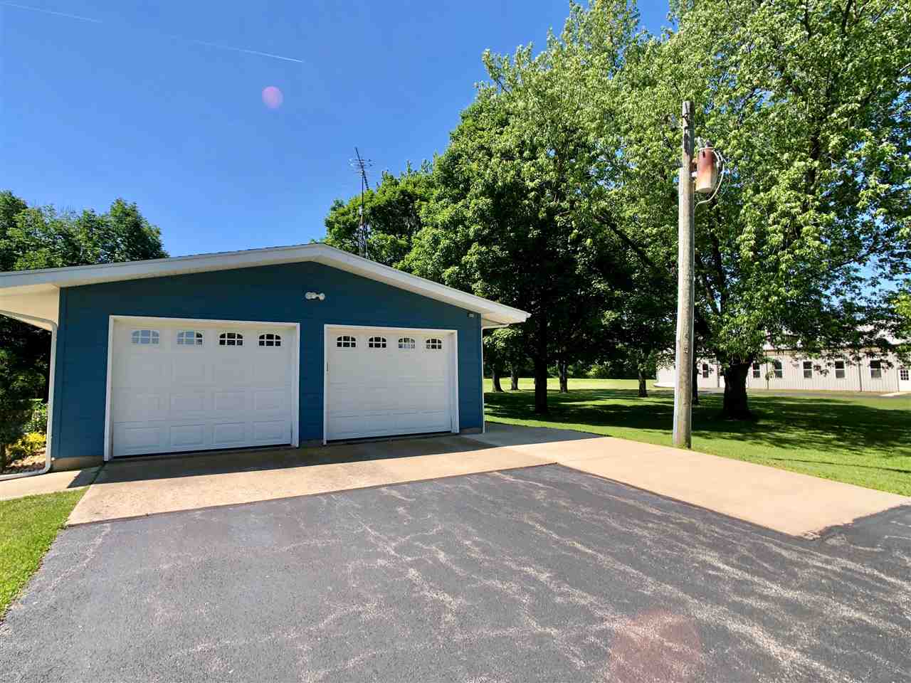747 Searls Road Amboy, IL 61310 - Photo 7 of 40 a view of a house with backyard and trees