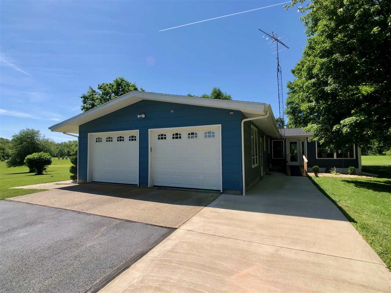 747 Searls Road Amboy, IL 61310 - Photo 8 of 40 a front view of a house with a garden
