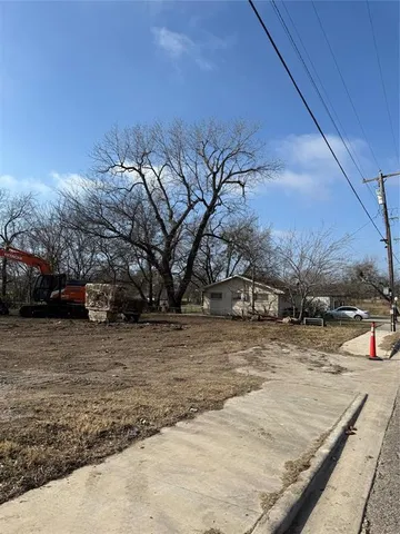 a view of a yard with snow on the road