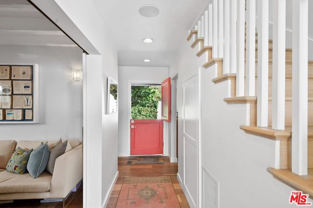 a view of hallway with furniture and a window