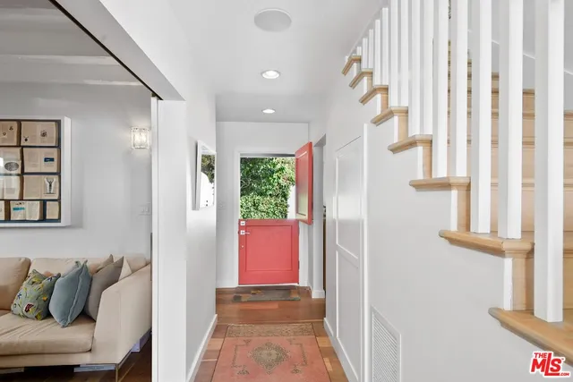 a view of hallway with furniture and a window