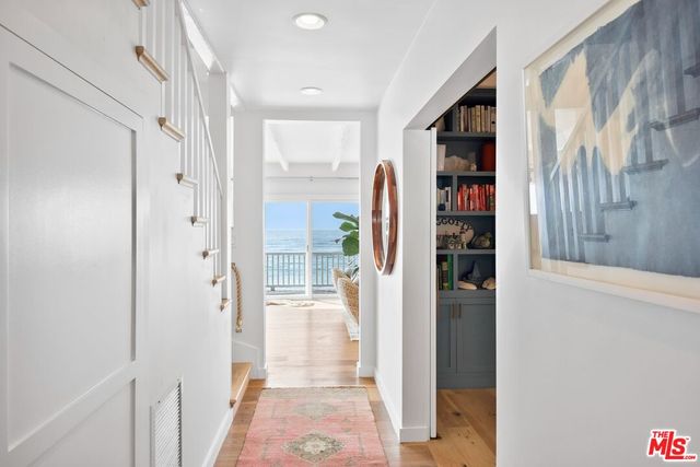a view of closet with clothes and shoes