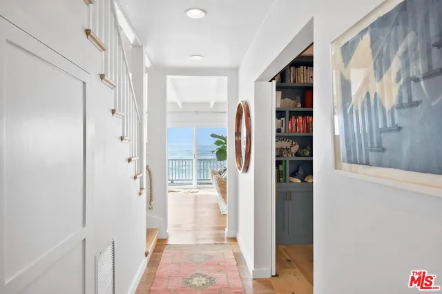 a view of closet with clothes and shoes