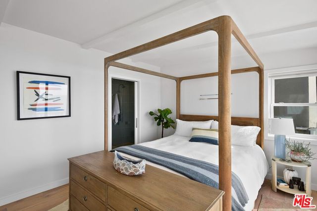 a bedroom with a bed and window