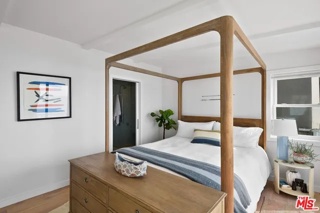 a bedroom with a bed and window