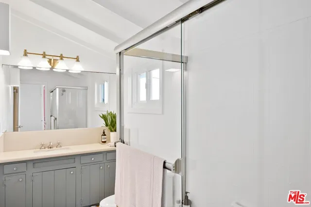 a bathroom with a double vanity sink and mirror