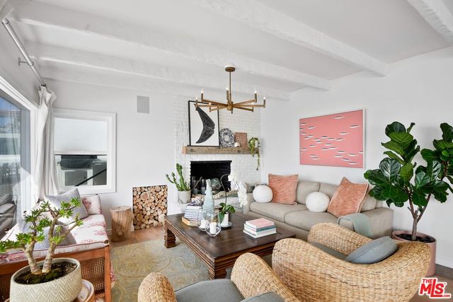 a living room with furniture potted plant and a fireplace