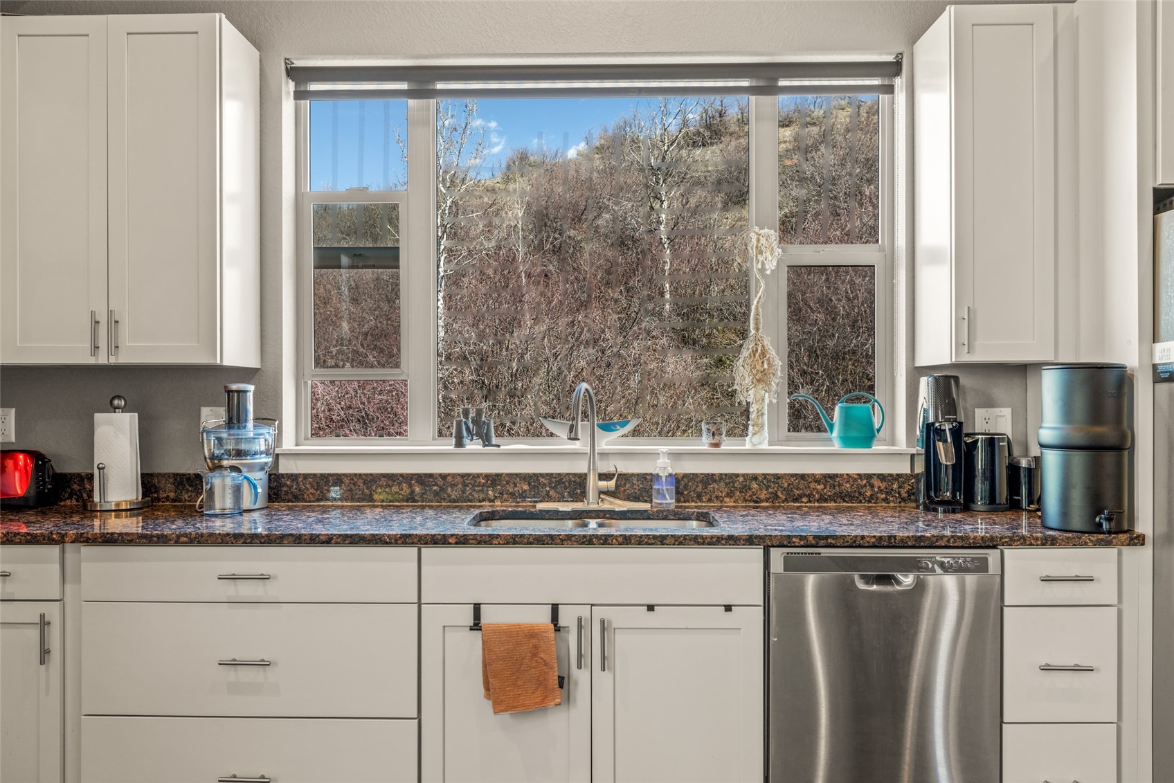1680 Copper Ridge Drive, Unit 101 Steamboat Springs, CO 80487 - Photo 14 of 21 a kitchen with granite countertop a sink and a window