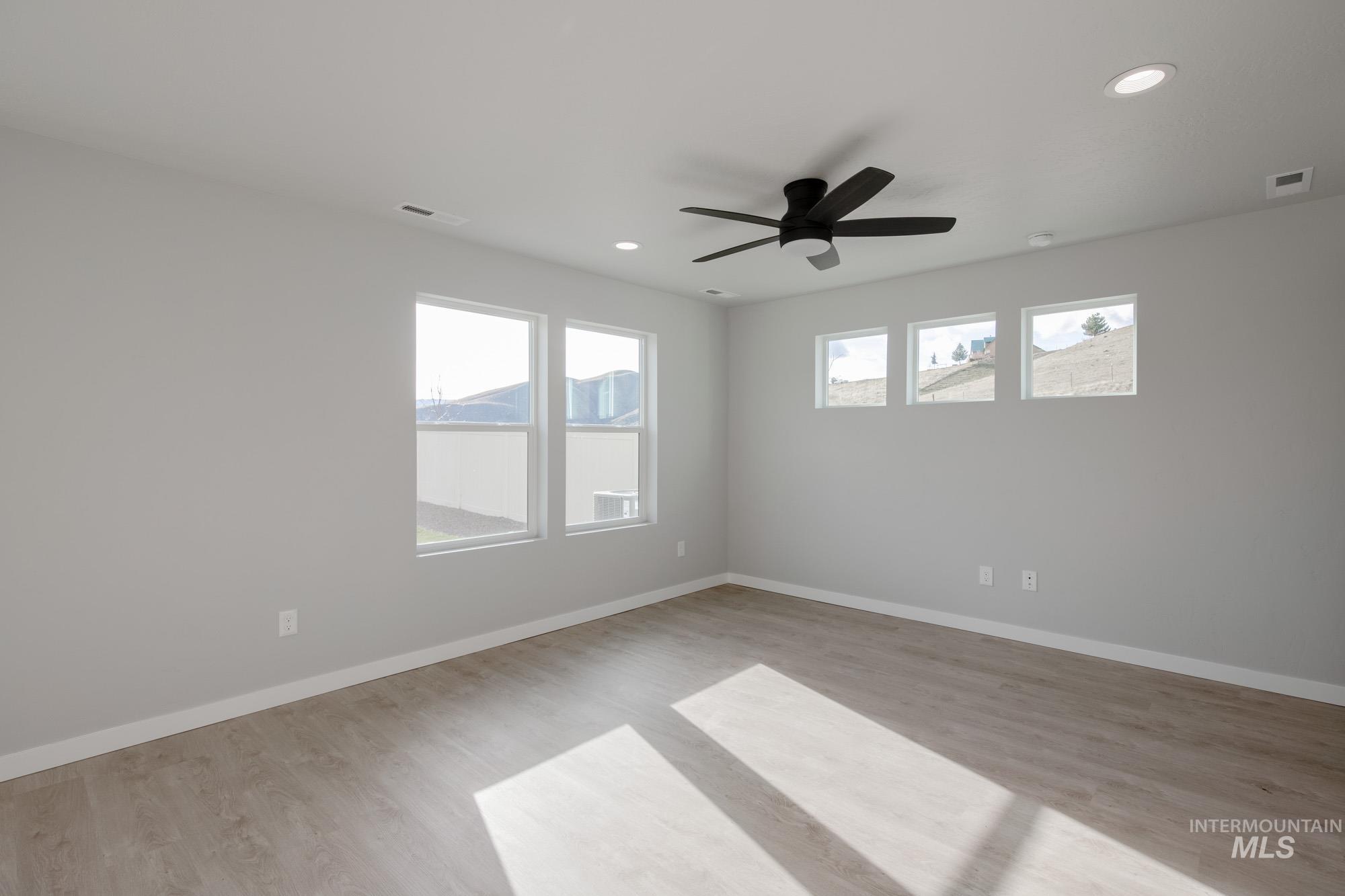 229 Moose Street Horseshoe Bend, ID 83629 - Photo 12 of 27 Unfurnished room with light wood-style floors, recessed lighting, and a ceiling fan