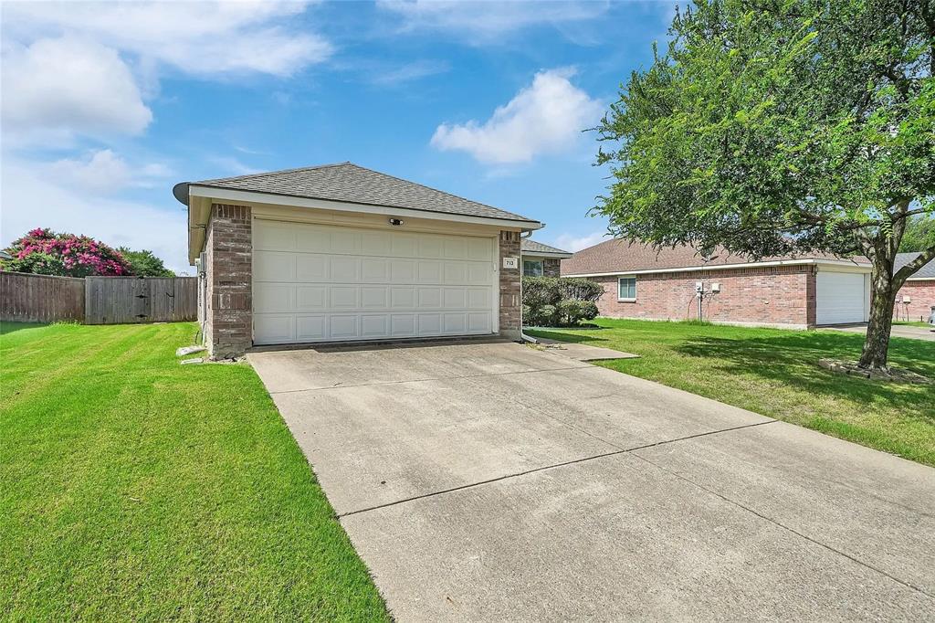 713 Baldwin Road Wylie, TX 75098 - Photo 2 of 29 a front view of a house with a yard and garage