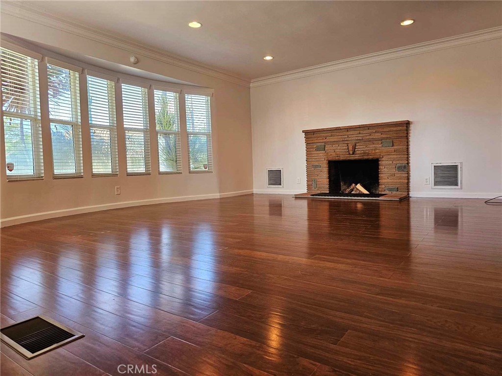 5259 Angeles Vista Boulevard View Park, CA 90043 - Photo 14 of 42 a view of empty room with wooden floor and fireplace