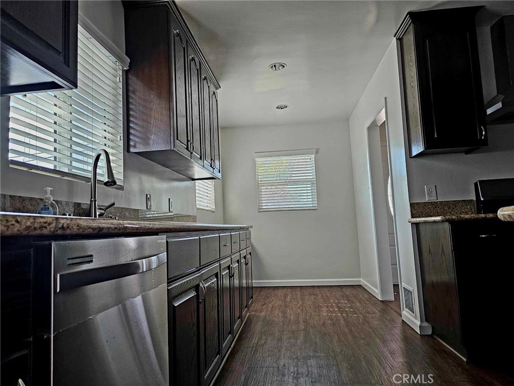 5259 Angeles Vista Boulevard View Park, CA 90043 - Photo 21 of 42 a kitchen with stainless steel appliances granite countertop a stove a sink and a refrigerator