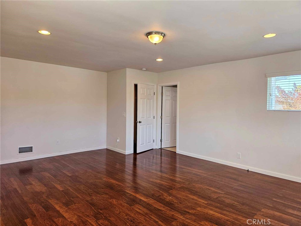 5259 Angeles Vista Boulevard View Park, CA 90043 - Photo 23 of 42 a view of an empty room with wooden floor