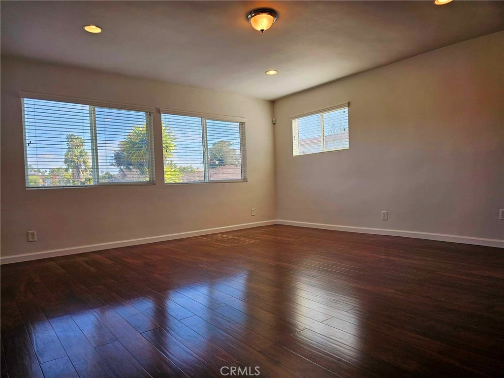 5259 Angeles Vista Boulevard View Park, CA 90043 - Photo 24 of 42 a view of an empty room with wooden floor and a window