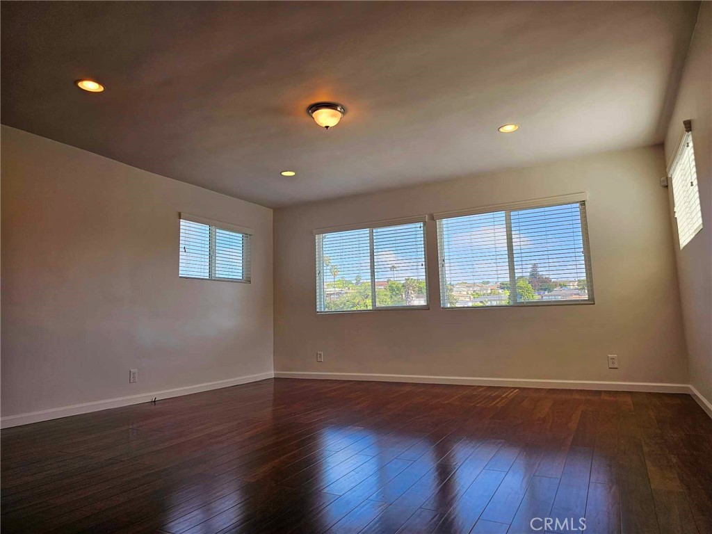 5259 Angeles Vista Boulevard View Park, CA 90043 - Photo 25 of 42 a view of an empty room with wooden floor and a window