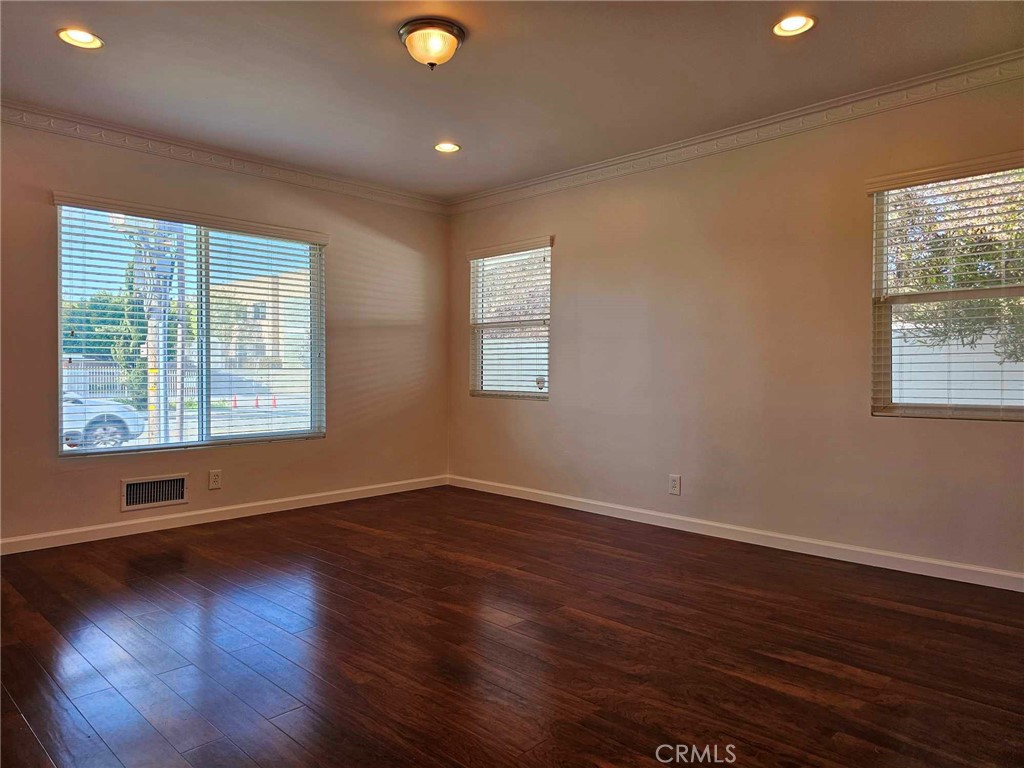 5259 Angeles Vista Boulevard View Park, CA 90043 - Photo 29 of 42 a view of an empty room with wooden floor and a window