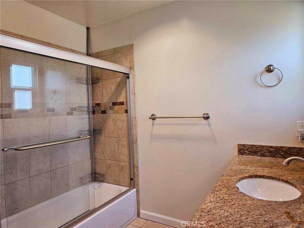 5259 Angeles Vista Boulevard View Park, CA 90043 - Photo 31 of 42 a bathroom with a sink a mirror a toilet and shower