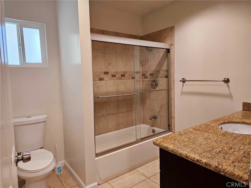 5259 Angeles Vista Boulevard View Park, CA 90043 - Photo 32 of 42 a bathroom with a granite countertop sink toilet and shower