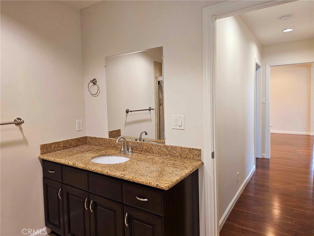 5259 Angeles Vista Boulevard View Park, CA 90043 - Photo 33 of 42 a bathroom with a sink and a mirror