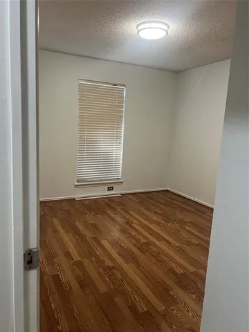 a view of room with wooden floor