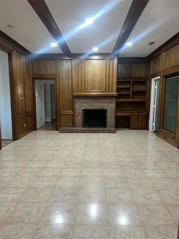 a view of an empty room with a fireplace
