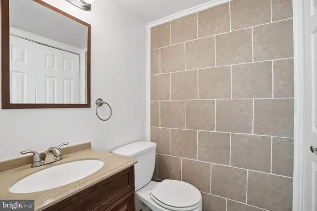 a bathroom with a sink toilet vanity and shower