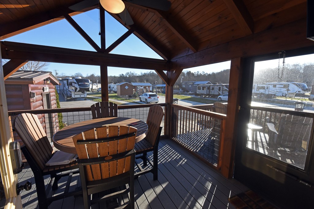 52 Foggy Mountain Road Blairsville, GA 30512 - Photo 6 of 50 a view of a balcony with furniture and wooden floor