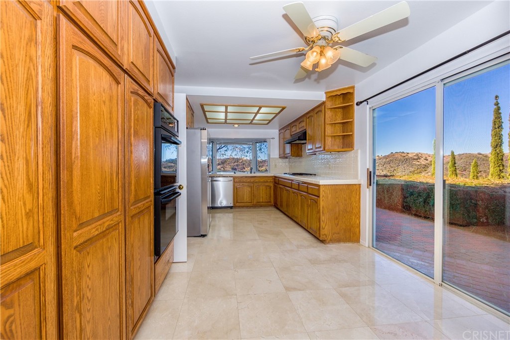 3117 Voltaire Drive Topanga, CA 90290 - Photo 5 of 14 a kitchen with stainless steel appliances granite countertop a stove a sink dishwasher and a refrigerator with wooden floor