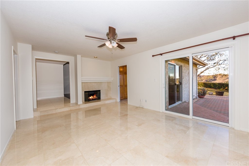 3117 Voltaire Drive Topanga, CA 90290 - Photo 6 of 14 a view of an empty room with a fireplace and a window