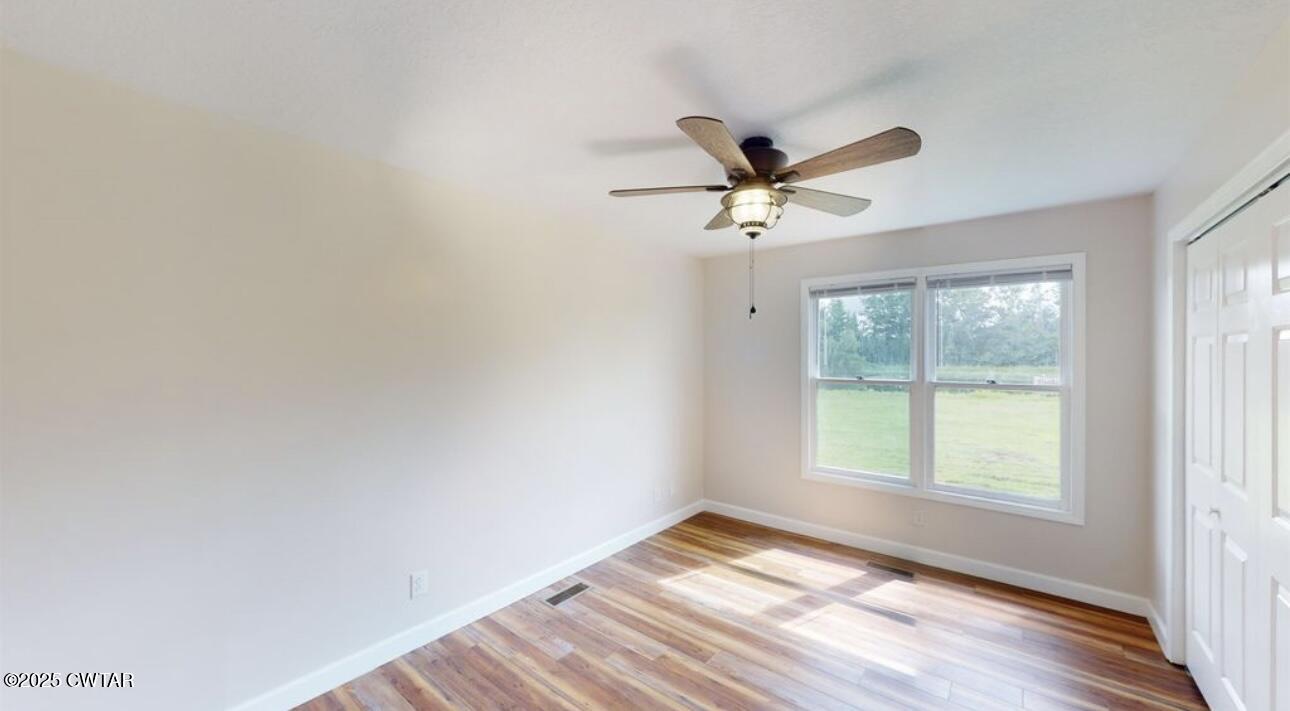 40 J D Barr Road Milan, TN 38358 - Photo 11 of 28 a view of empty room with wooden floor and fan