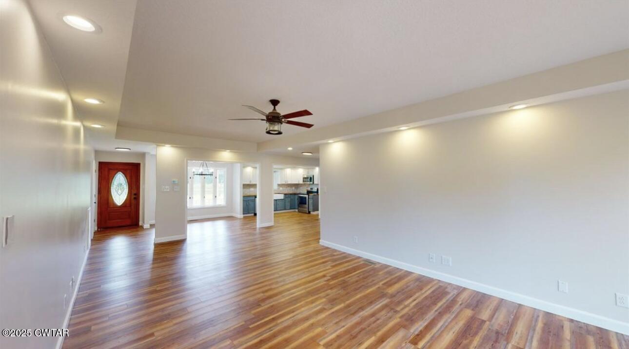 40 J D Barr Road Milan, TN 38358 - Photo 7 of 28 a view of an empty room with window and wooden floor