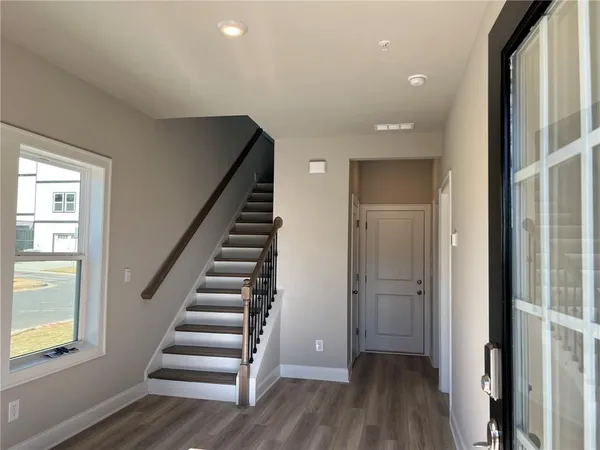 a view of entryway with wooden floor and stairs