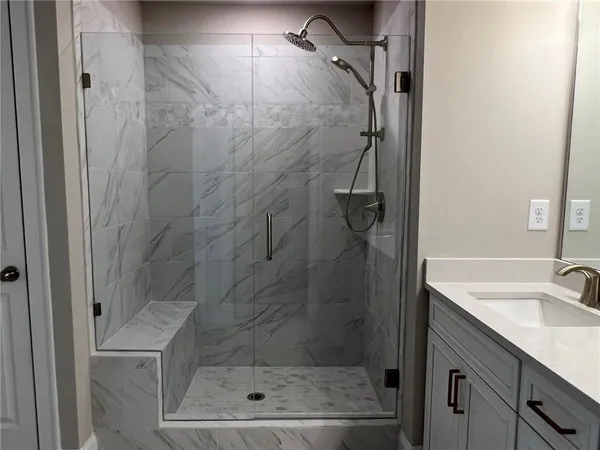 a bathroom with a shower and a sink