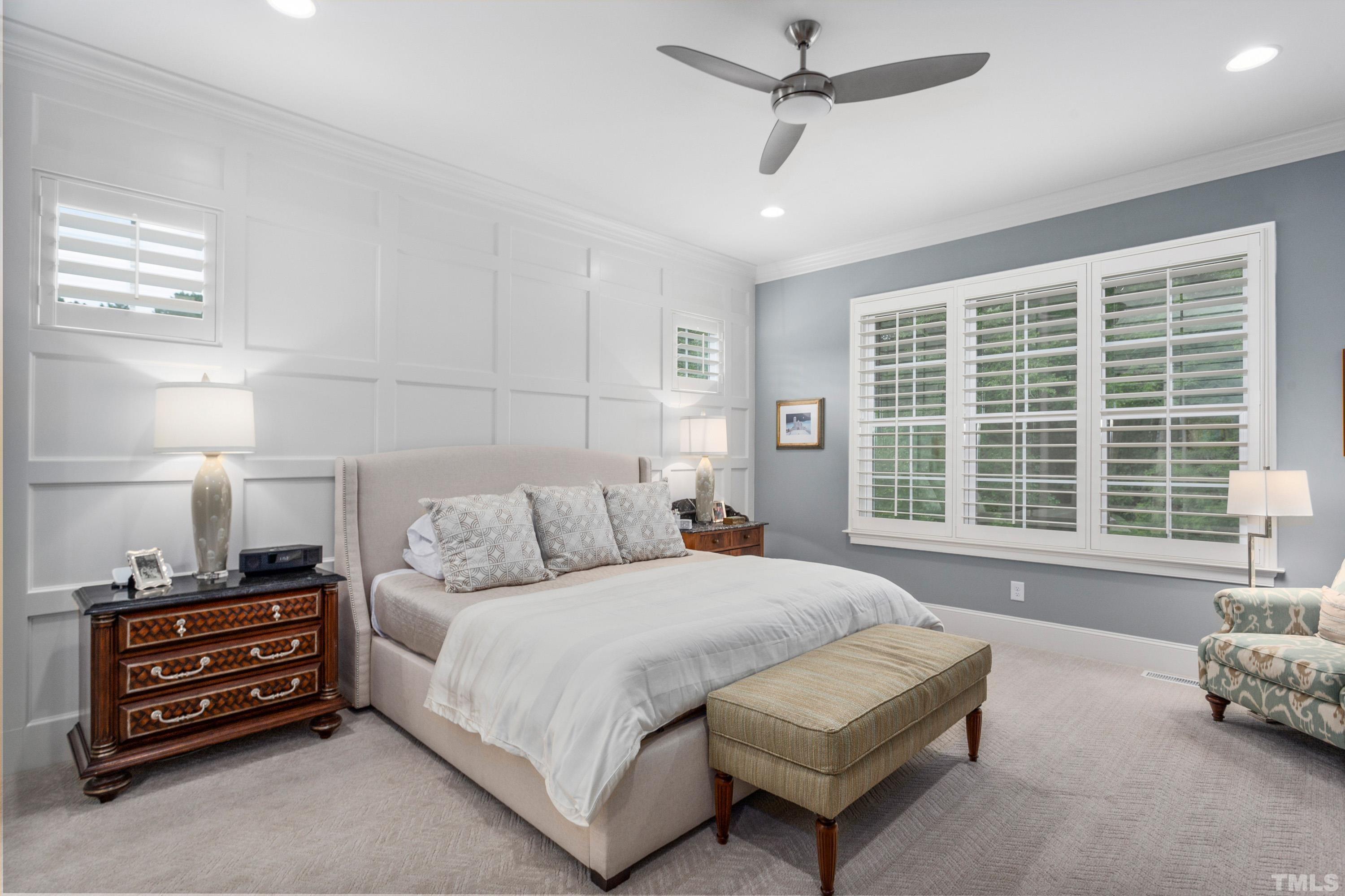 3013 Colmar Manor Drive Cary, NC 27519 - Photo 16 of 53 a spacious bedroom with a bed a couch and a window