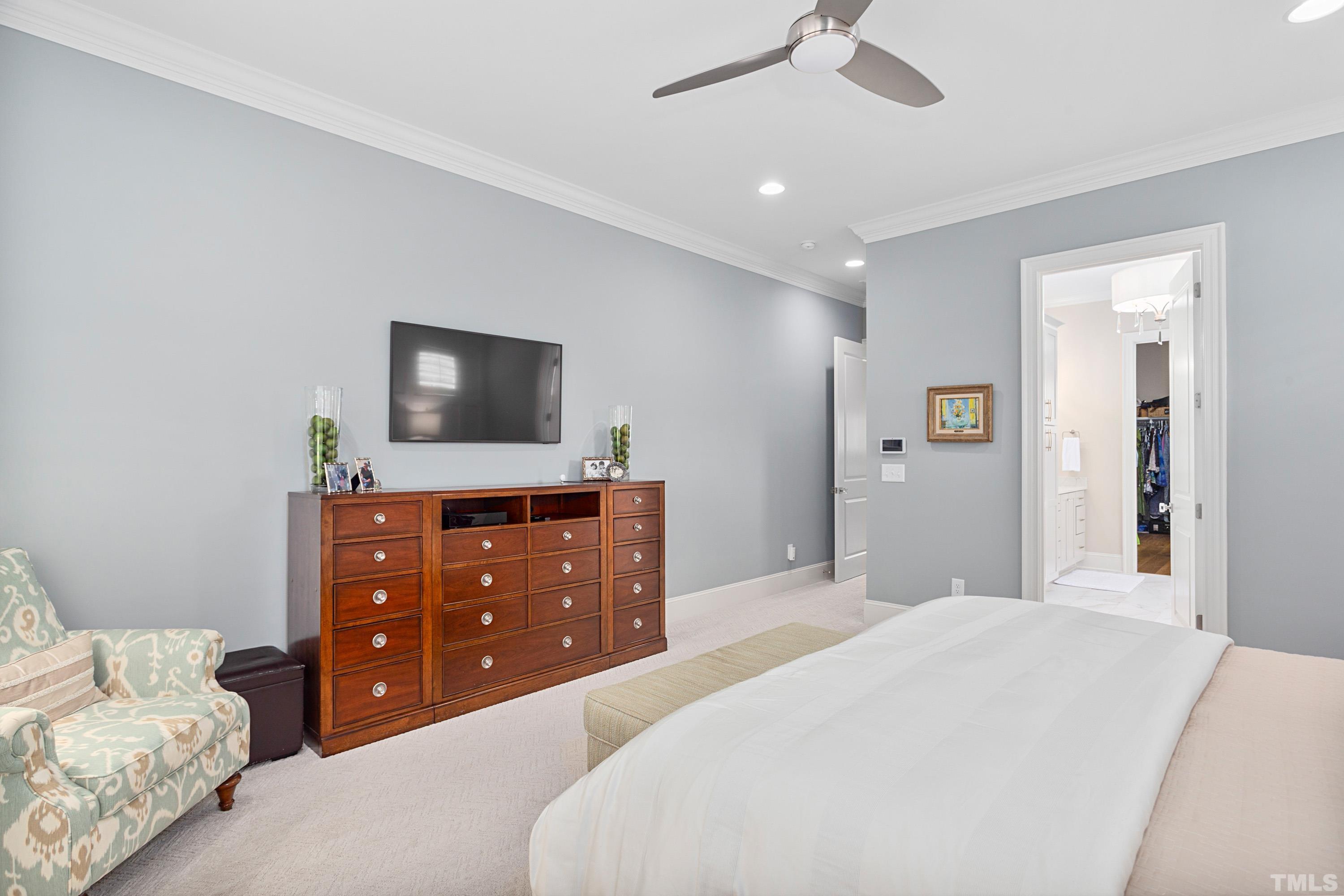 3013 Colmar Manor Drive Cary, NC 27519 - Photo 20 of 53 a bedroom with a bed and a flat screen tv