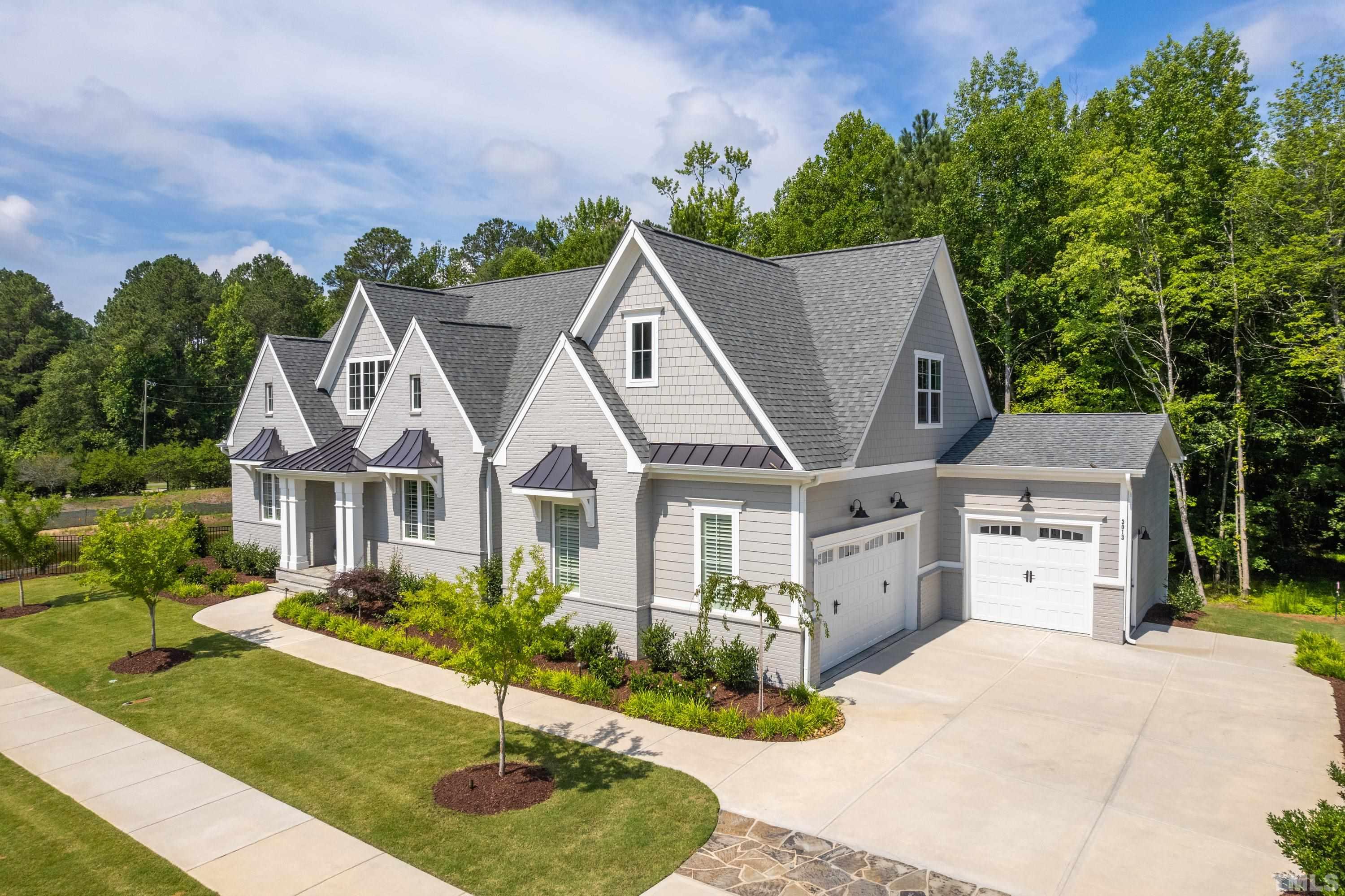 3013 Colmar Manor Drive Cary, NC 27519 - Photo 2 of 53 a view of a house with a garden