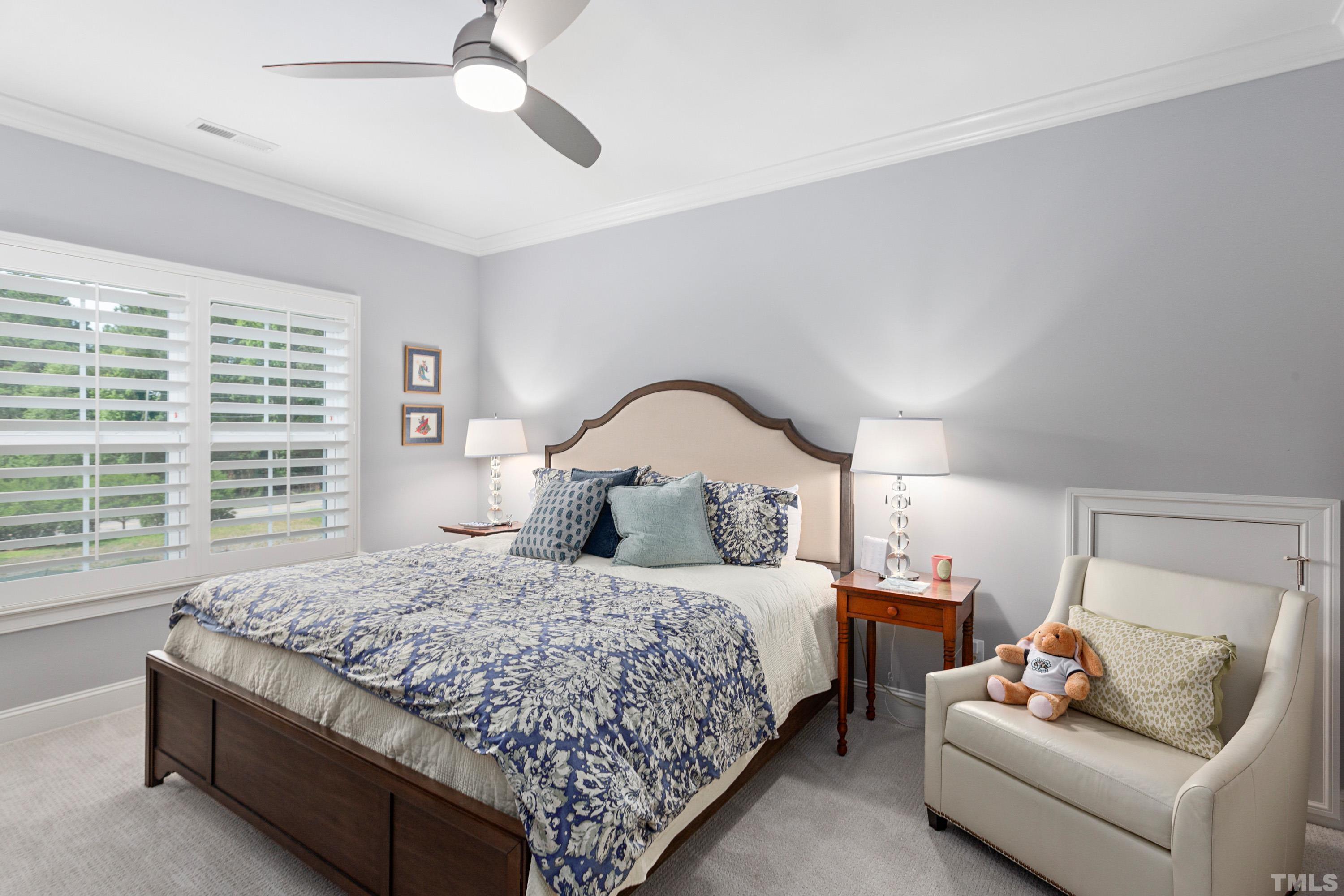 3013 Colmar Manor Drive Cary, NC 27519 - Photo 32 of 53 a bedroom with a bed and a couch